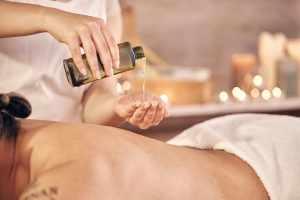 Spa therapy, massage oil and man with luxury care, wellness and muscle relax with hands, stress rel