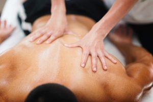 Sports massage. Physical therapist massaging athlete's back